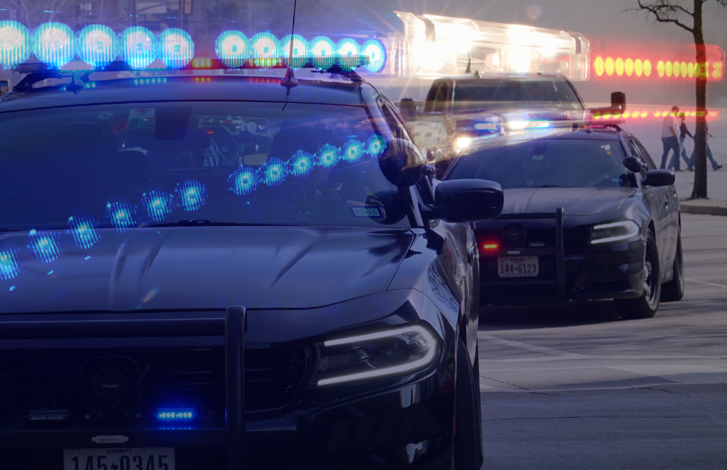 Police vehicles with flashing emergency lights during a traffic stop or roadside response.